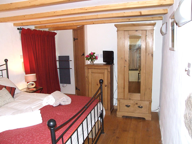 The bedroom with wardrobe and king sized bed